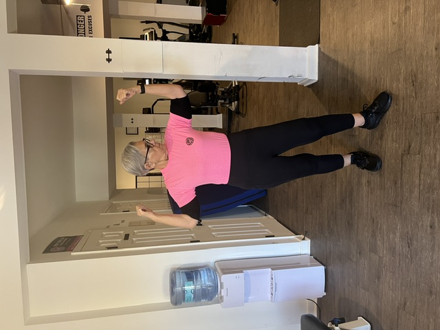 Body Temple VA member flexing with strength and joy at 76